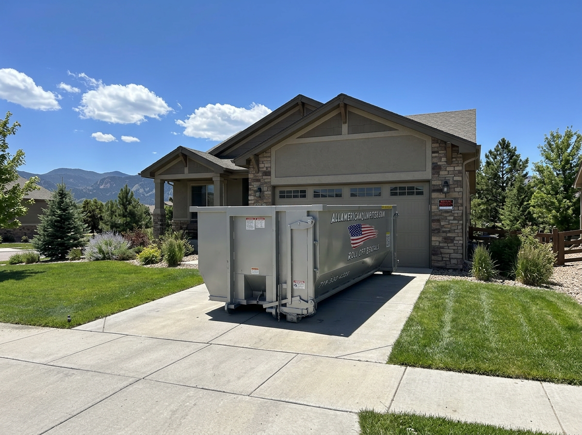 Residential dumpster rental in Colorado Springs, CO: an All American Dumpster roll-off on a home driveway with Pikes Peak foothills behind